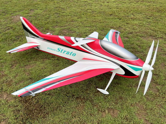 Model airplane with 'Strato' branding on a grassy field