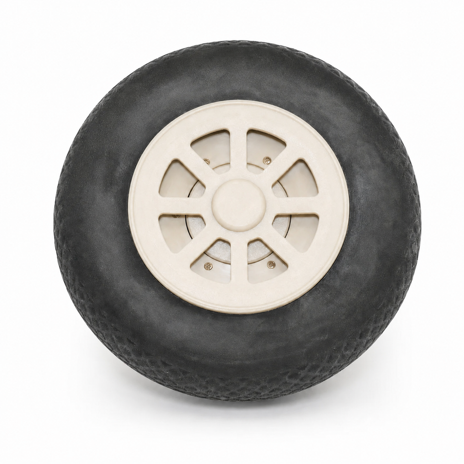 A single black rubber tire with a cream-colored plastic hub and center cap, shown from a top-down view on a white background.