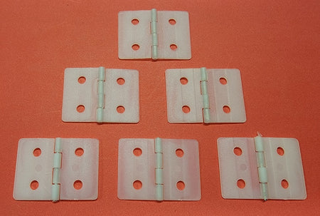Six plastic hinges on a red background